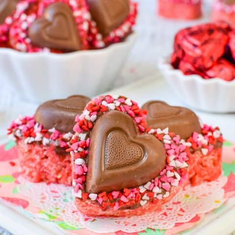 Heart shaped rice krispie treats with a chocolate heart on them.