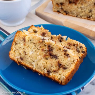 Two slices of almond banana bread laying on a blue plate.