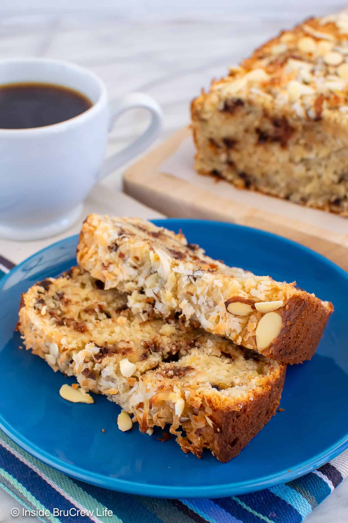 Two slices of almond banana bread on a blue plate.