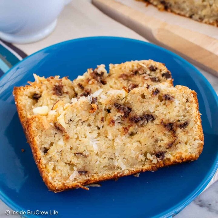 Two slices of almond joy banana bread laying on a blue plate.