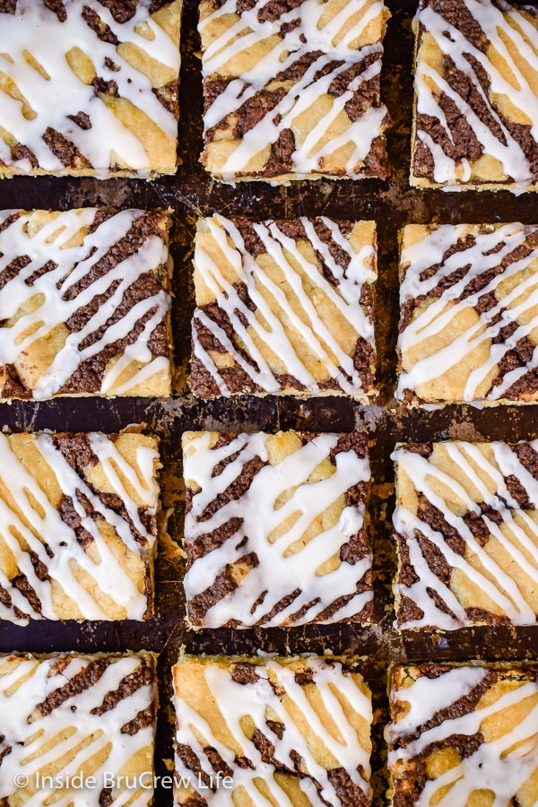 Overhead picture of squares of banana nutella snack cake on a metal tray