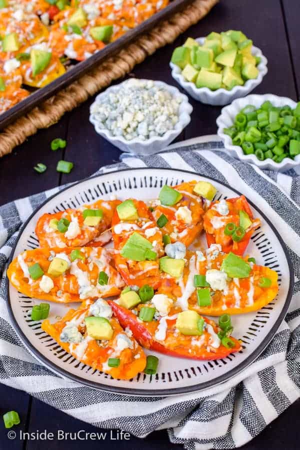 Buffalo Chicken Pepper Nachos - this easy low carb appetizer is filled with buffalo chicken and cheese. Easy recipe to make for game day parties or dinner! #buffalochicken #lowcarb #appetizer #healthy #sheetpanmeal