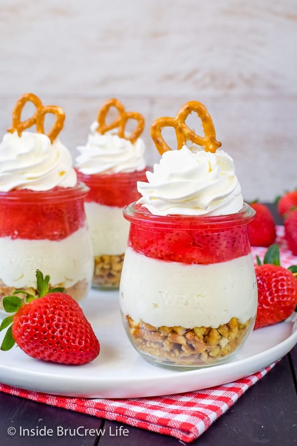 Strawberry Pretzel Salad Parfaits - the sweet and salty layers in these no bake parfaits will have everyone reaching for more. Try this easy recipe for dessert! #strawberry #pretzelsalad #nobake #cheesecake #homemadepiefilling #smalldesserts