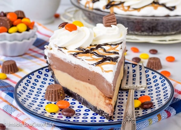 A slice of Peanut Butter Pie with layers of chocolate pudding and Cool Whip on top