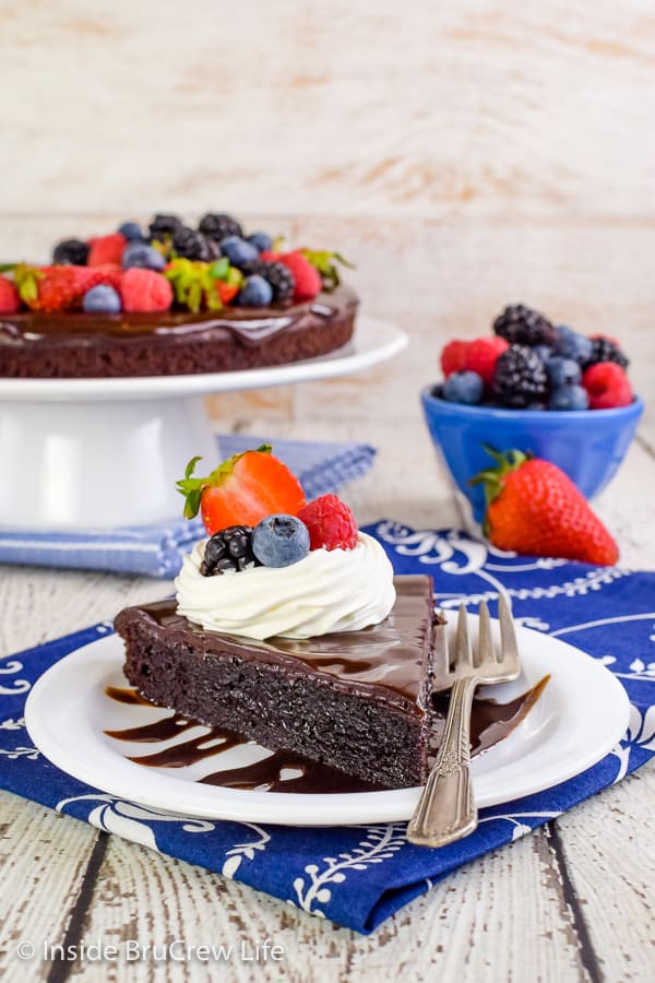 Best Flourless Chocolate Cake - this easy flourless chocolate cake is topped with more chocolate and fresh berries and tastes amazing! Make this easy recipe and wow everyone at dessert! #chocolate #flourless #chocolatecake #easyrecipe #glutenfree