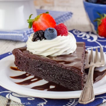 A slice of gooey chocolate torte on a white plate.