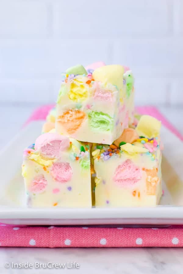 Easy Fruity Marshmallow Fudge - this easy two ingredient fudge gets a fun color and taste from the marshmallows and sprinkles. Make this easy recipe for spring parties! #easter #twoingredientfudge #fudge #whitechocolate #fruitymarshmallows #easterfudge