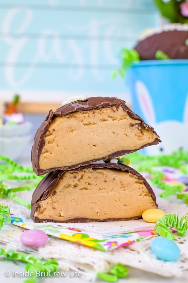 A homemade Reese's Egg cut in half and stacked on top of each other showing the thick peanut butter filling in the eggs.