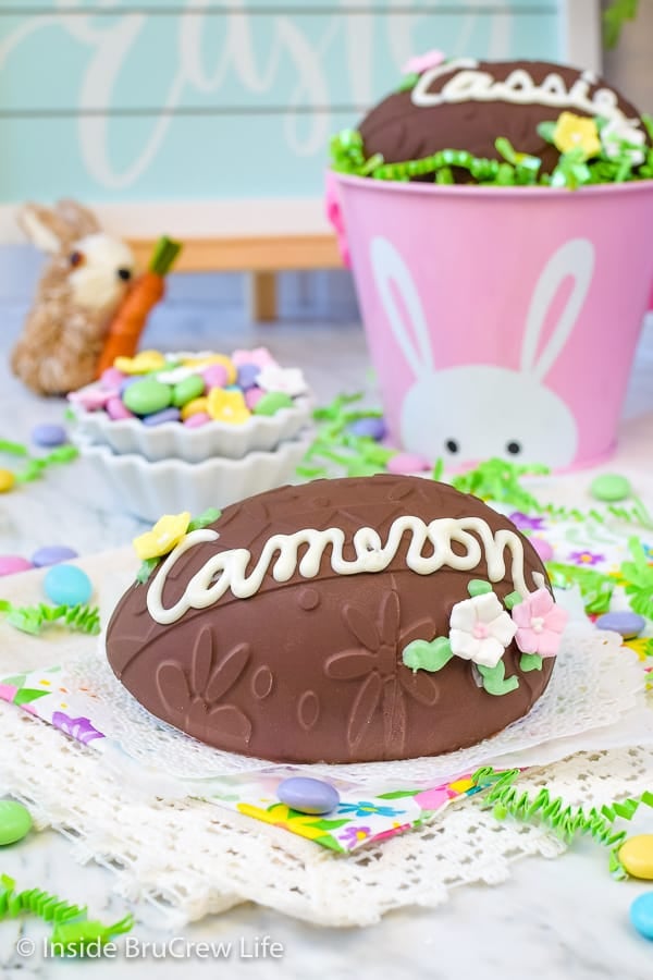 Easter candies and napkins with a large chocolate peanut butter egg with a name and candies on them.