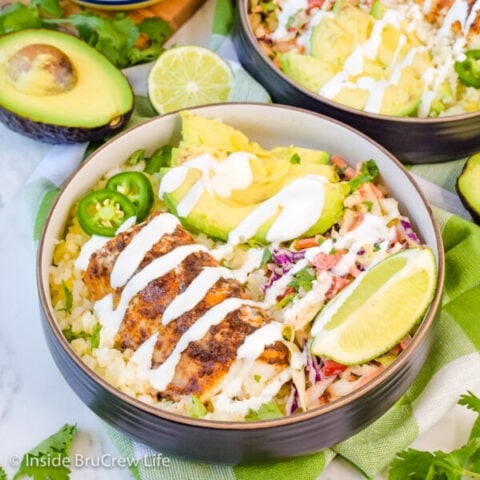 A fish taco bowl drizzled with lime crema.