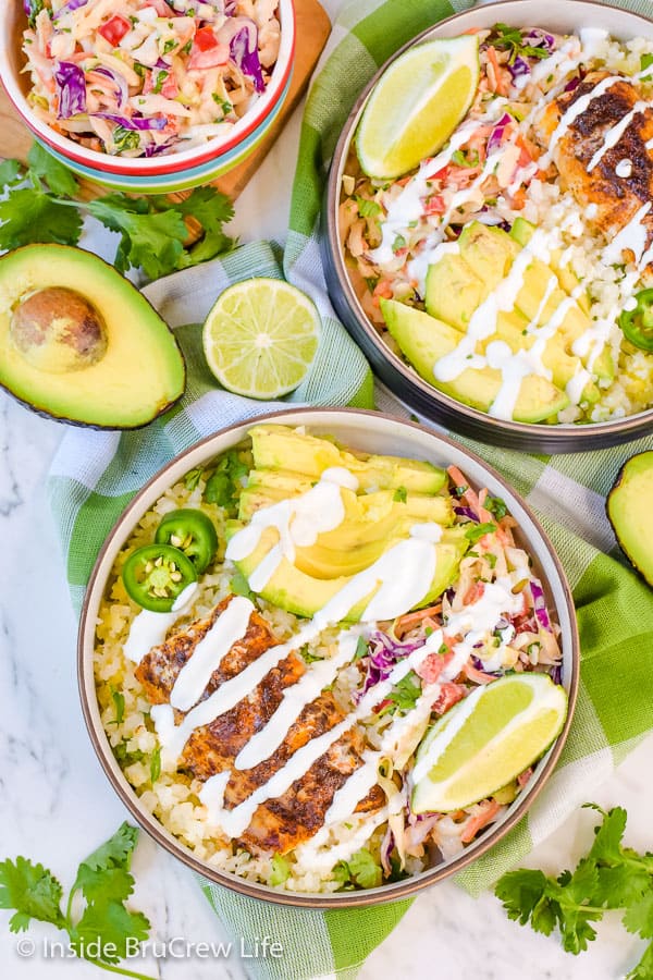 Picture of the top of a fish taco bowl with fish, rice, coleslaw, and crema drizzle.