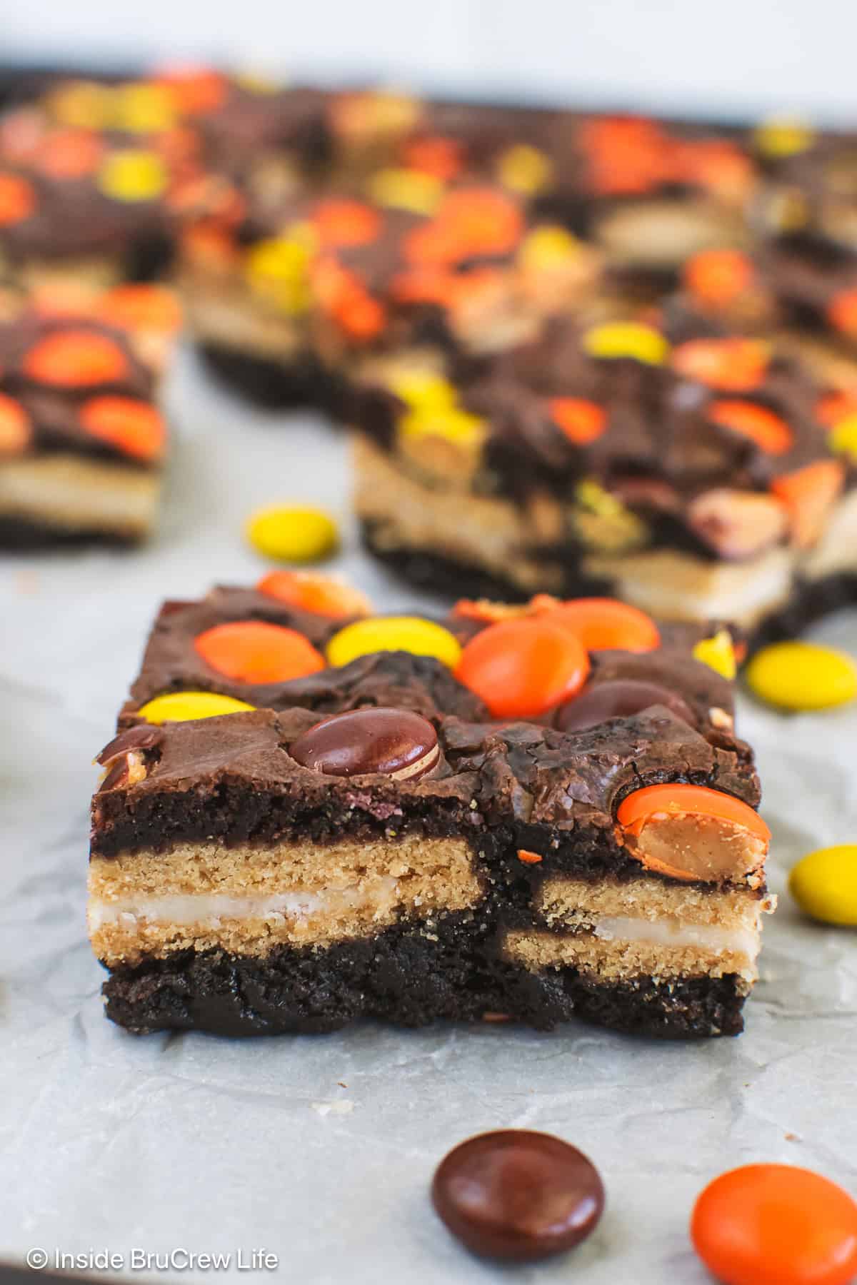 Squares of Oreo stuffed Reese's Pieces on a pan.