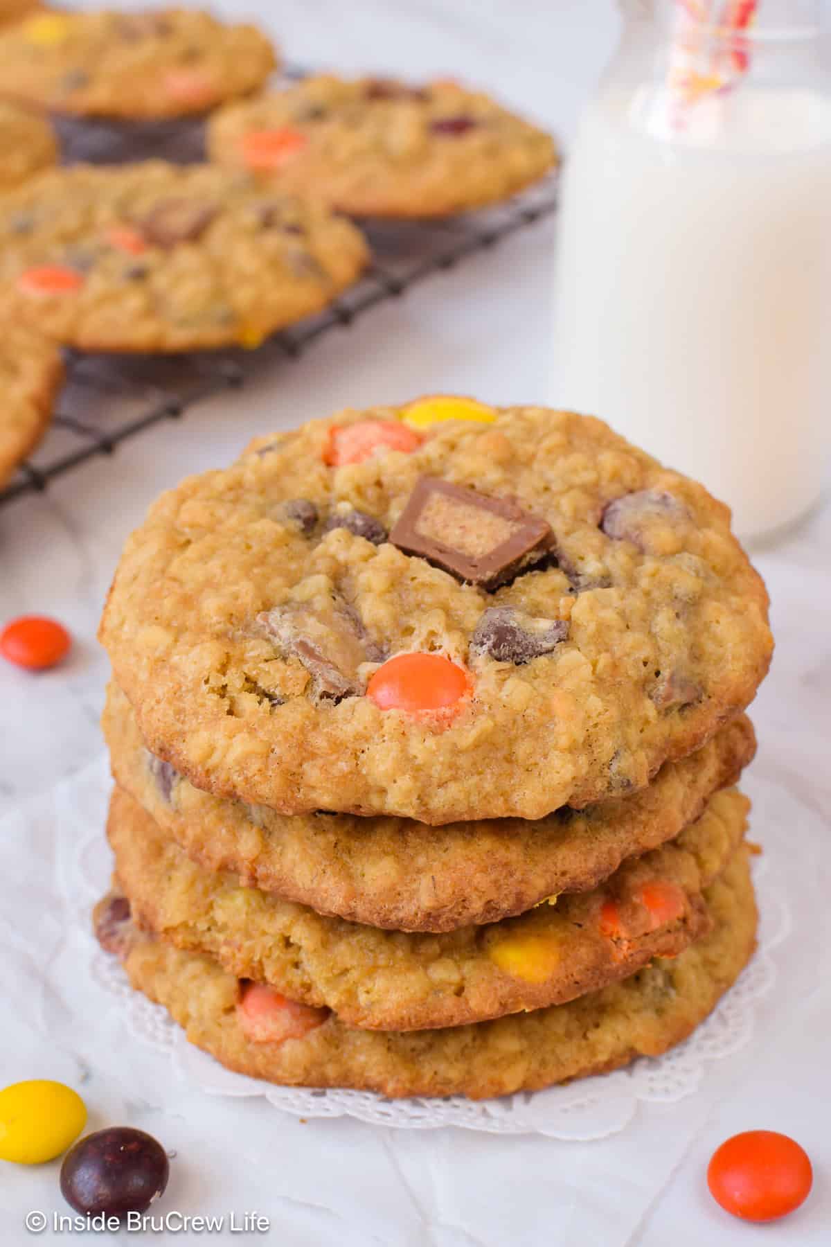 A stack of peanut butter oatmeal cookies topped with Reese's candies.