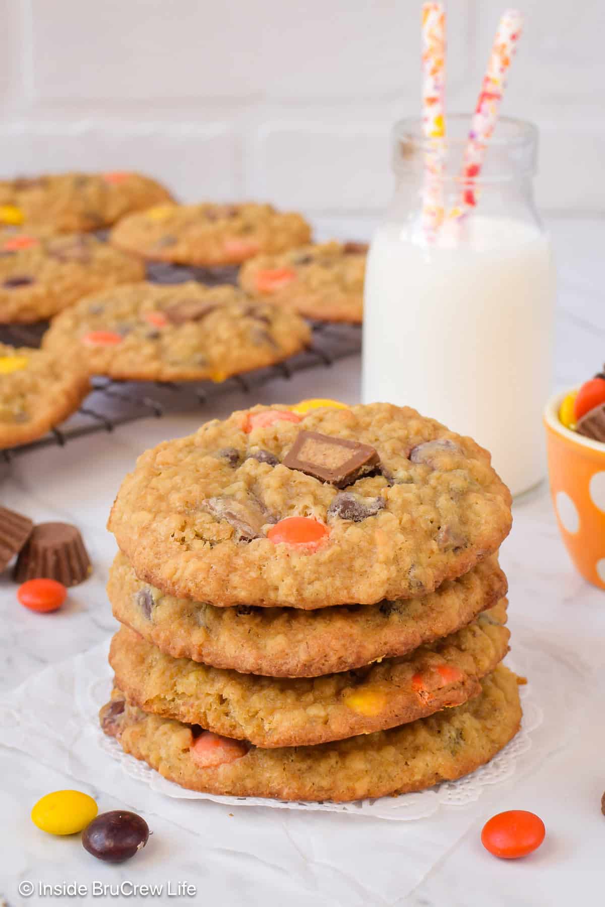 A stack of chewy peanut butter banana oatmeal cookies made with Reese's candies.