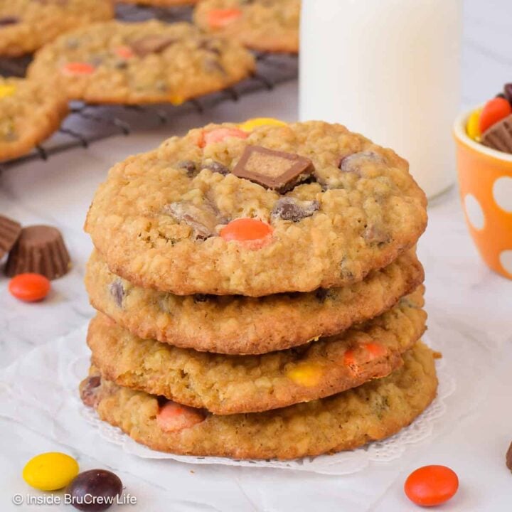 A stack of chewy peanut butter banana oatmeal cookies made with Reese's candies.
