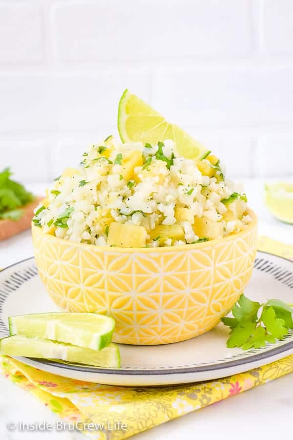 Pineapple Lime Cauliflower Rice - a bowl of this easy cauliflower rice gets it's flavor from pineapple, lime, and cilantro. Make this easy and healthy recipe to go with tacos, fajitas, fish, or grilled chicken. #healthy #cauliflower #pineapple #rice