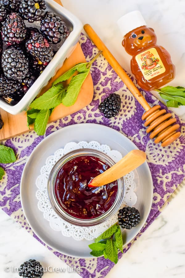 Overhead picture of a jar of seedless blackberry preserves and a box of blackberries.