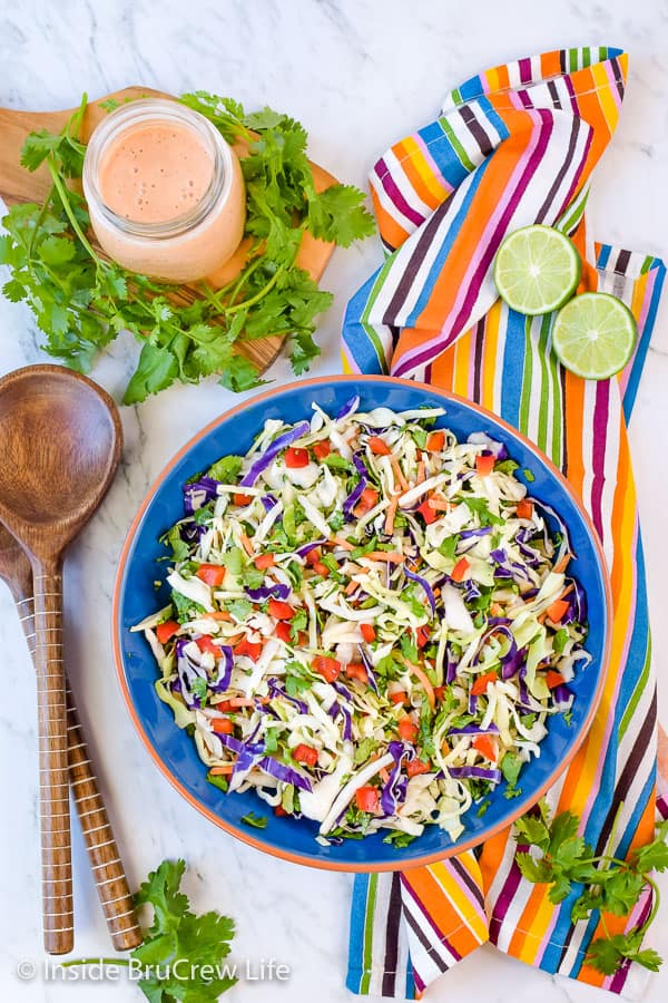 Sweet and Spicy Coleslaw - a Sriracha and honey dressing gives this easy coleslaw a great sweet and spicy flavor. Try this easy recipe for pork or fish dinners! #coleslaw #sweetandspicy #sriracha #honey #summer #potluck