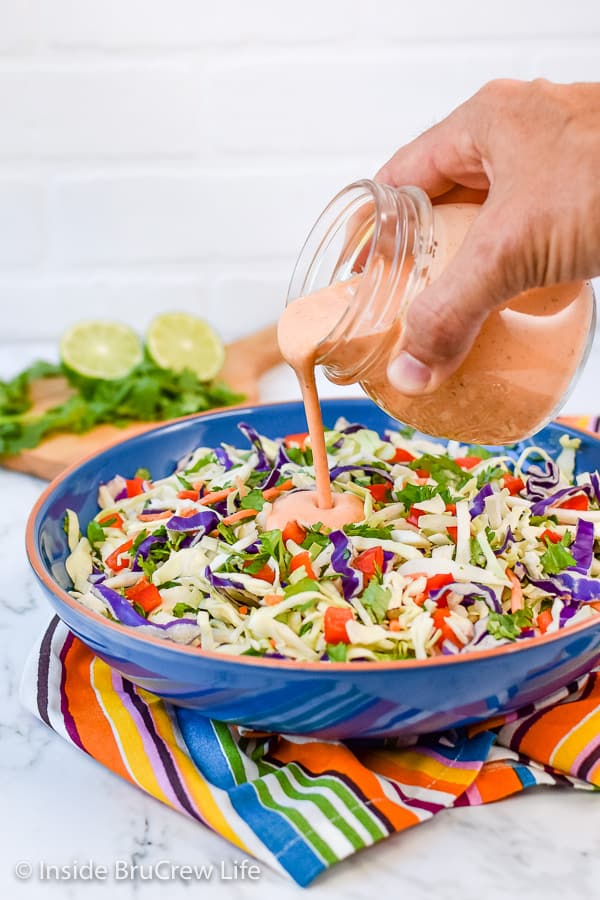 Sweet and Spicy Coleslaw - this easy coleslaw has a great sweet and spicy flavor from the honey and Sriracha dressing. Make this easy recipe to serve with pork or fish dinners! #coleslaw #sweetandspicy #sriracha #honey #summer #potluck