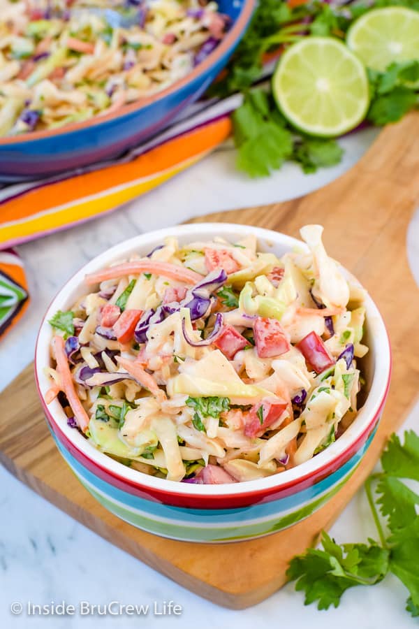 Sweet and Spicy Coleslaw - this easy coleslaw recipe comes together in minutes. Honey and Sriracha give it a great sweet and spicy flavor. #coleslaw #sweetandspicy #sriracha #honey #summer #potluck