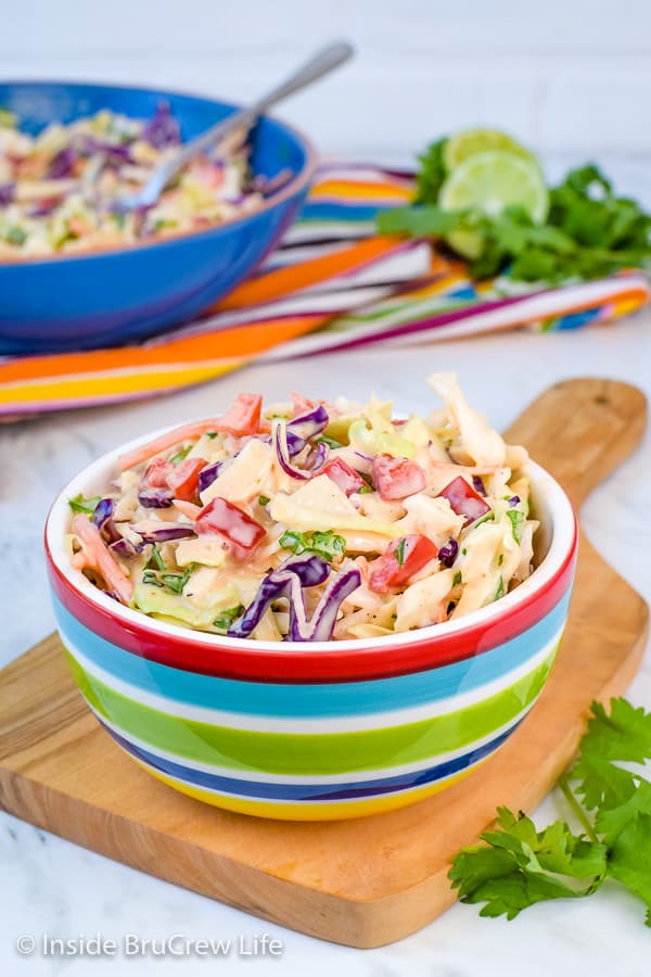 Sweet and Spicy Coleslaw - this easy coleslaw gets the sweet and spicy flair from honey and Sriracha. It's the perfect side dish for any pork or fish dinner. #coleslaw #sweetandspicy #sriracha #honey #summer #potluck