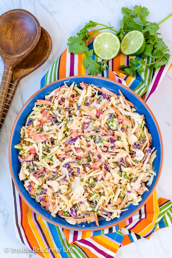 Sweet and Spicy Coleslaw - a bowl of this easy coleslaw is the perfect addition to pork or fish dinners. The sweet and spicy dressing adds a great flavor. #coleslaw #sweetandspicy #sriracha #honey #summer #potluck