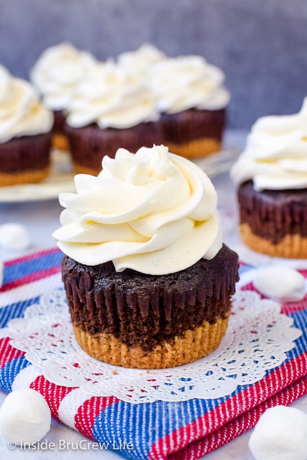 A chocolate cupcake topped with a swirl of marshmallow buttercream.