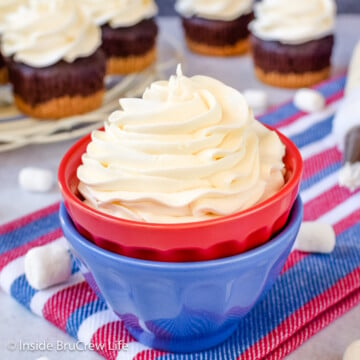 A swirl of buttercream in a red and blue bowl.