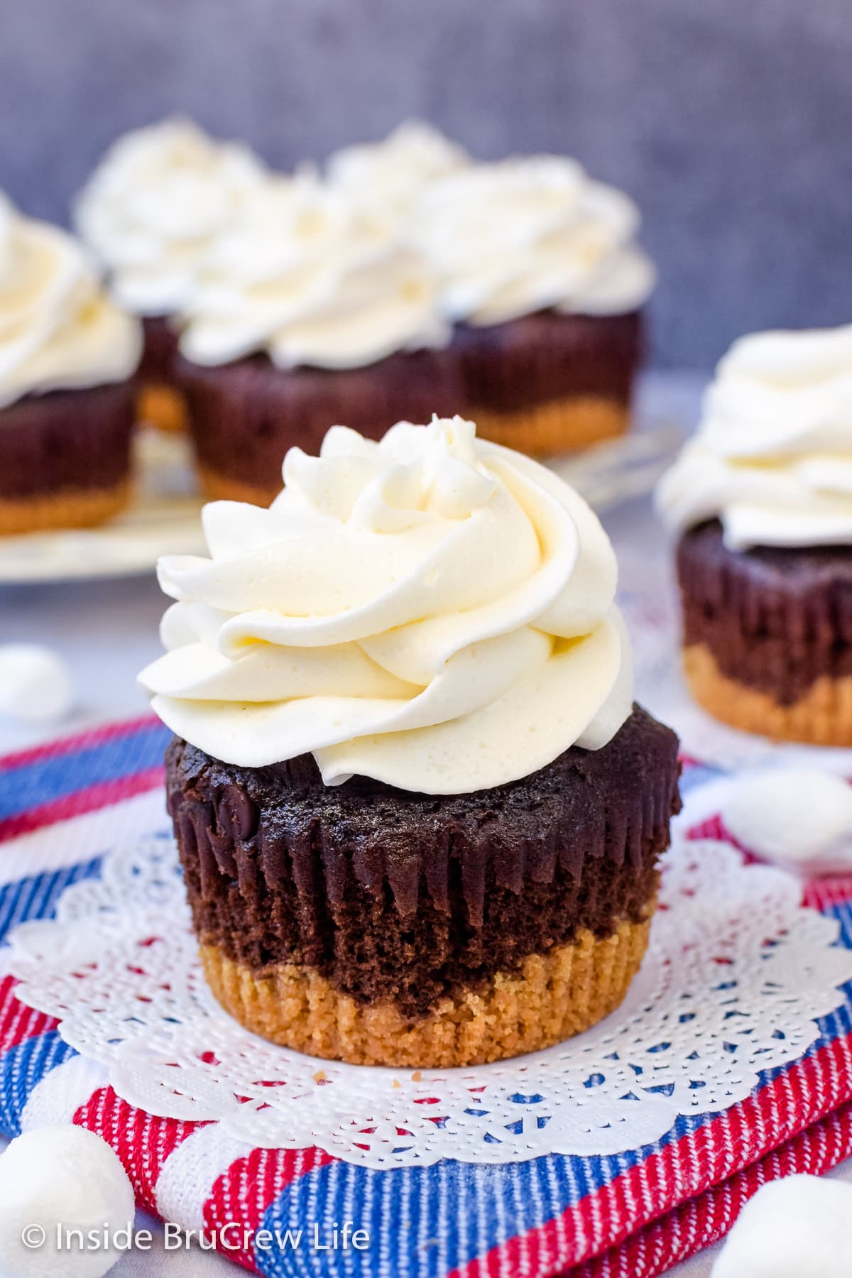 A chocolate s'mores cupcake topped with marshmallow fluff frosting.