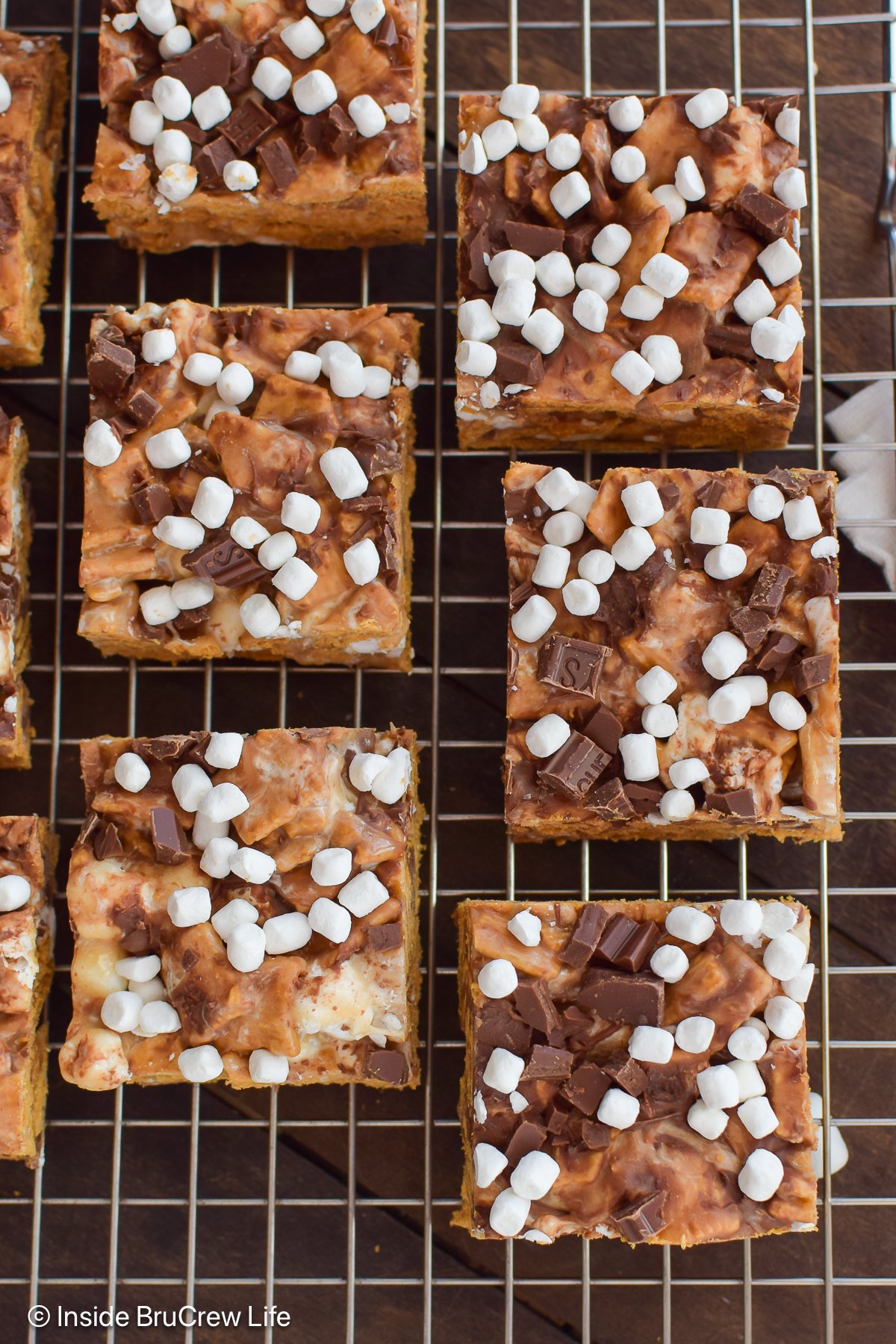 Squares of peanut butter s'mores bars on a wire rack.
