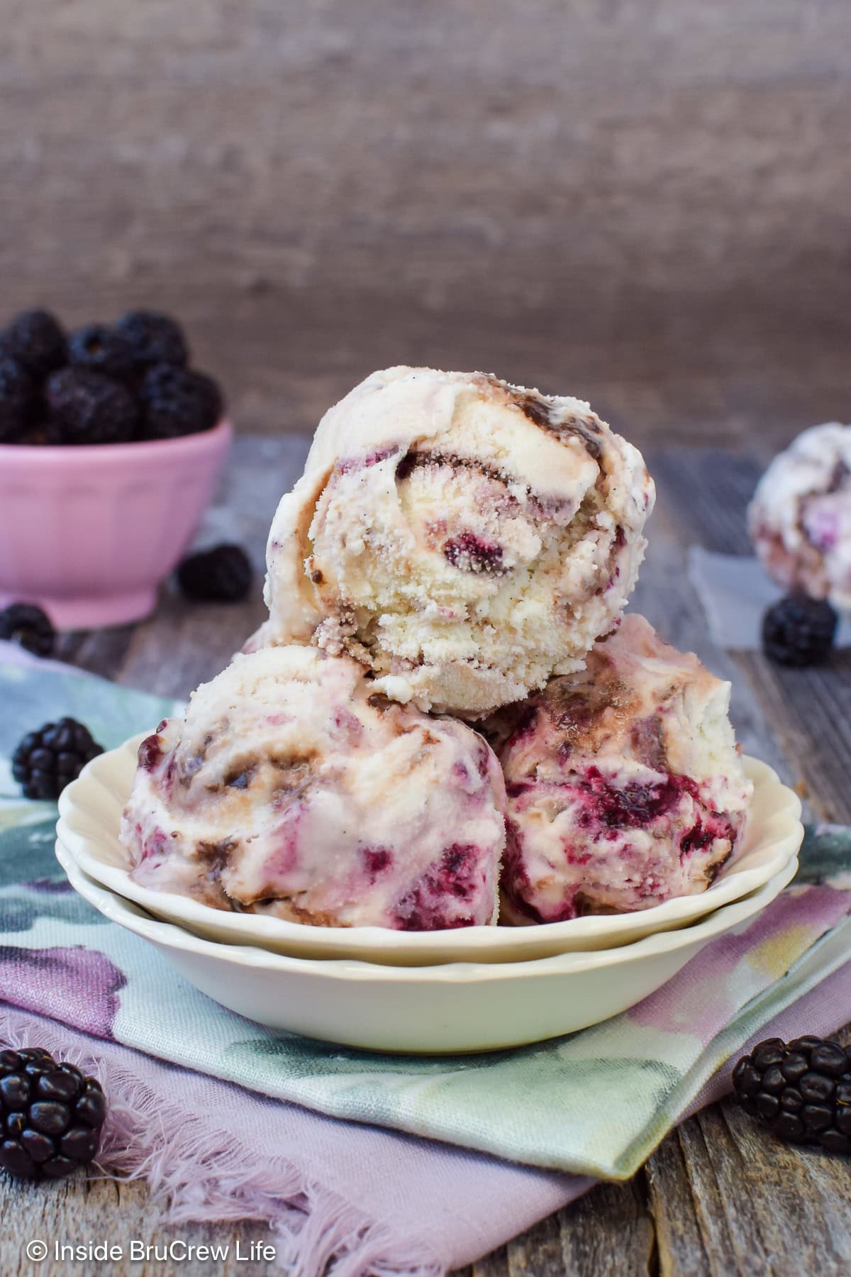 A bowl filled with fudge swirl ice cream scoops.
