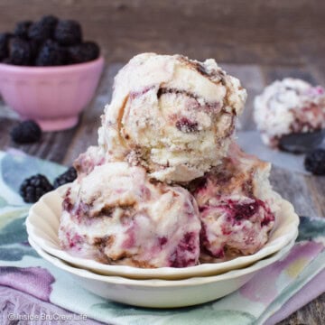 A bowl filled with three scoops of blackberry fudge swirl ice cream.