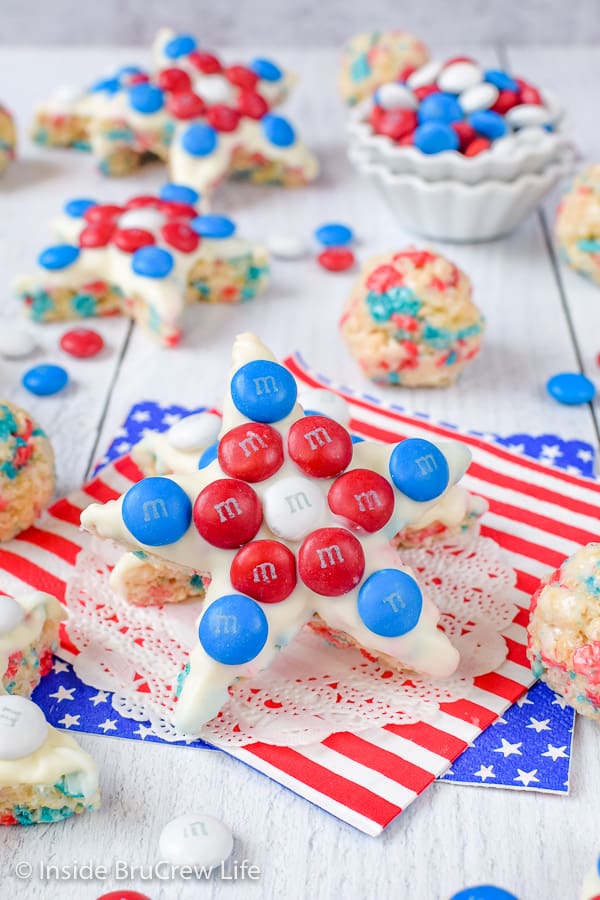 Rice krispie treat stars decorated with red white and blue M&Ms on a white board