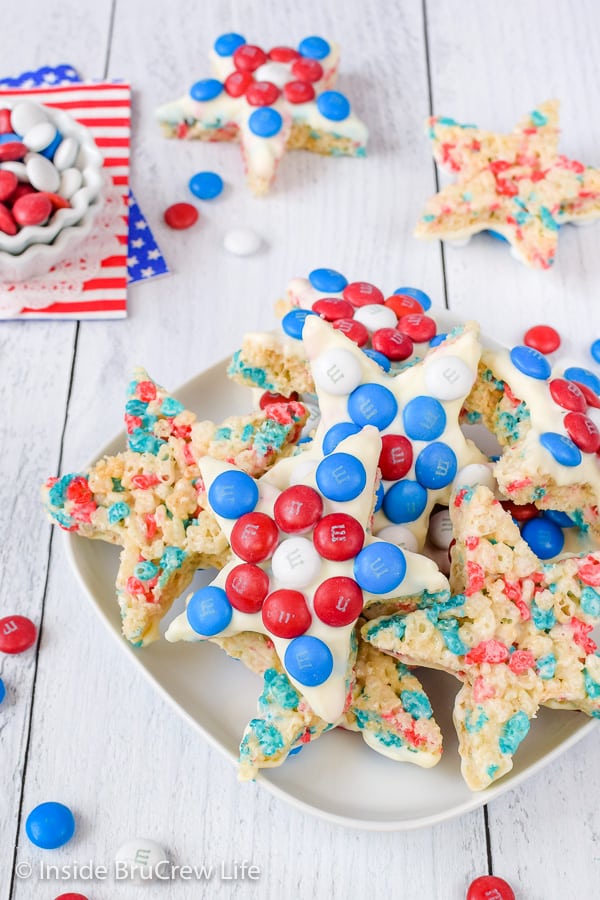 A white plate on a white board filled with red white and blue rice krispie treat stars