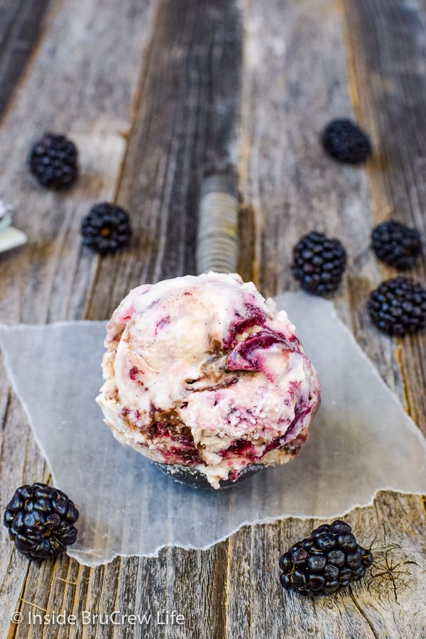 A scoop of blackberry fudge ice cream in an ice cream scooper.