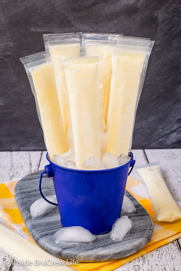 Easy Dole Whip Popsicles - these sweet and refreshing popsicles are a delicious copycat of the popular Disney dessert. Make a batch and enjoy them on hot days! #copycat #disney #dolewhip #popsicles #summerdessert #summerfun #summervibes #pineapple
