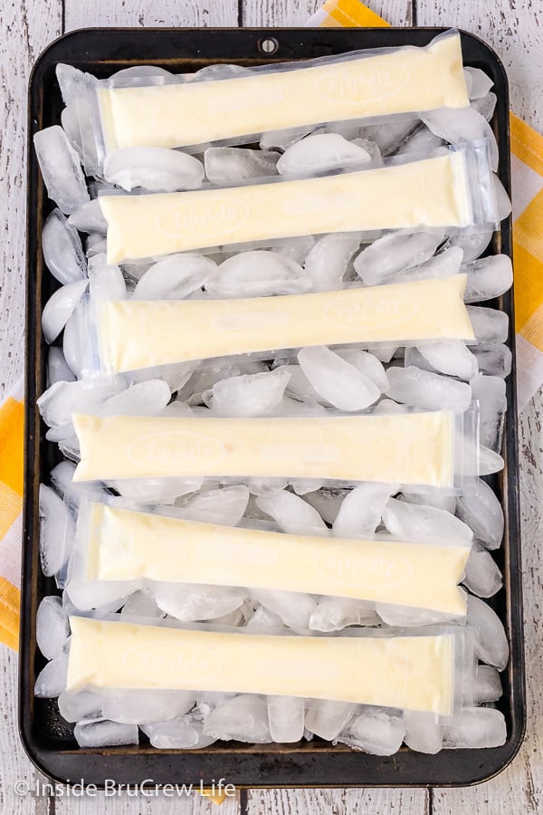 Easy Dole Whip Popsicles - these refreshing homemade popsicles taste just like the popular Disney treat. Make this easy recipe for your freezer and enjoy them on hot day! #copycat #disney #dolewhip #popsicles #summerdessert #summerfun #summervibes #pineapple