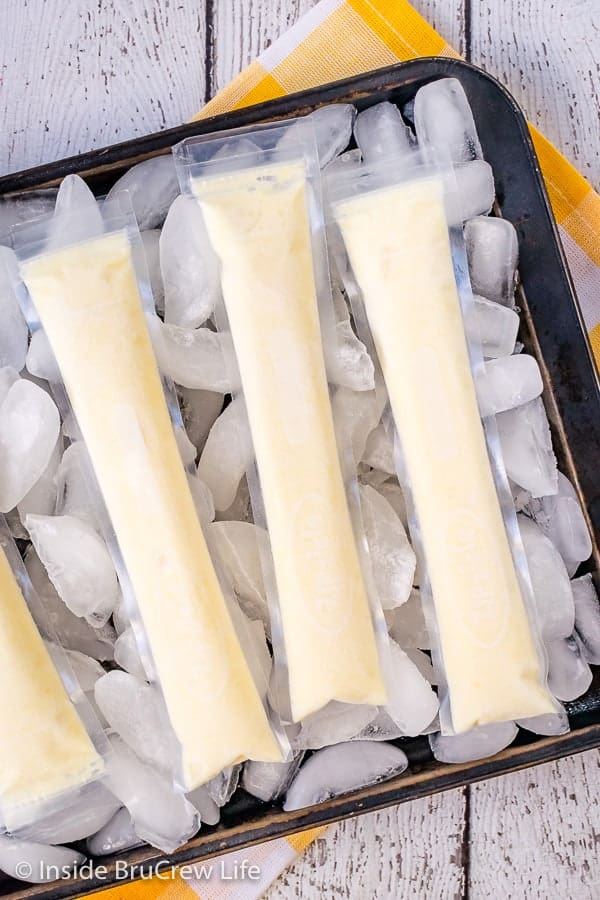 Easy Dole Whip Popsicles - all you need are a few ingredients and a blender to make these refreshing pineapple popsicles. Great recipe to enjoy when it is hot outside! #copycat #disney #dolewhip #popsicles #summerdessert #summerfun #summervibes #pineapple