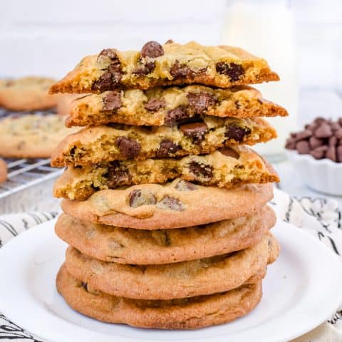 A stack of chocolate chip cookies on a white plate