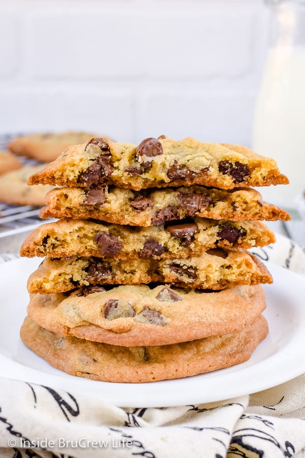 A white plate with two crisp and chewy chocolate chip cookies on it.