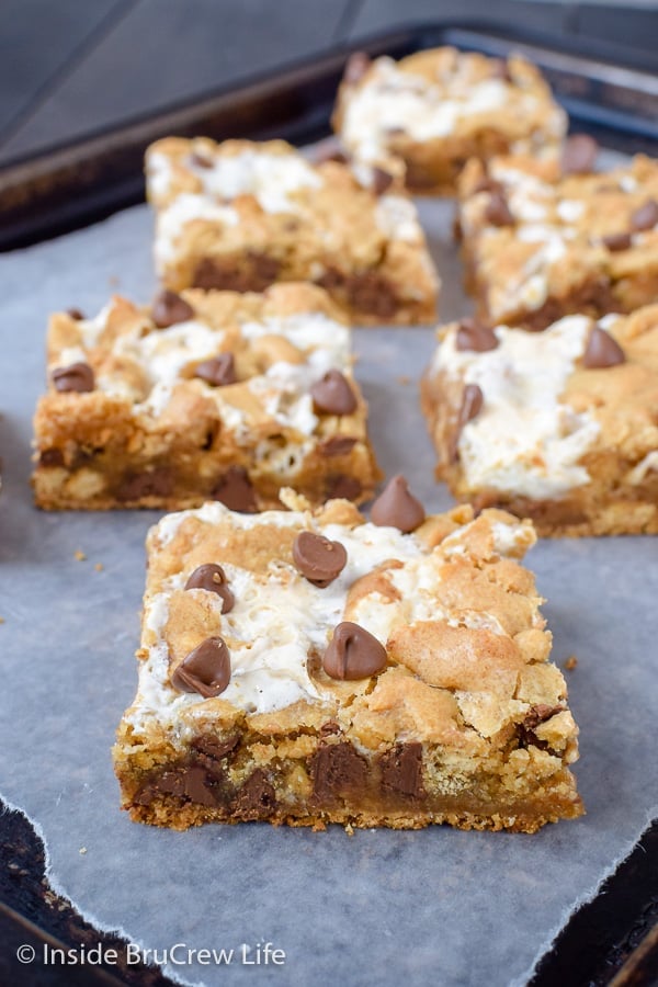 A metal tray with squares of s'mores bars on it.