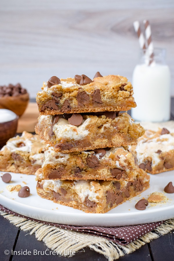 A white plate with a stack of s'mores blondies on it.