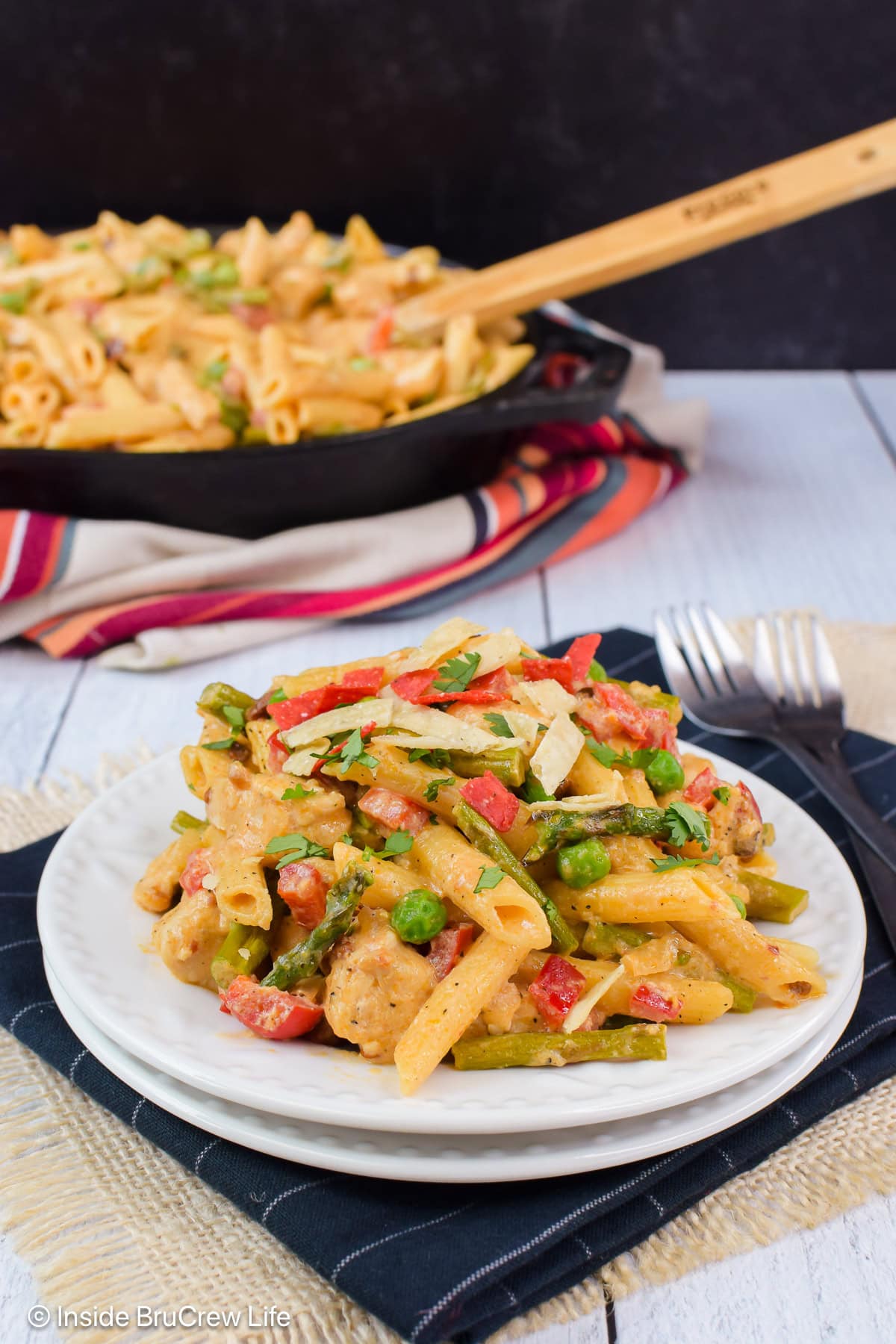 Spicy chicken pasta on a white plate.