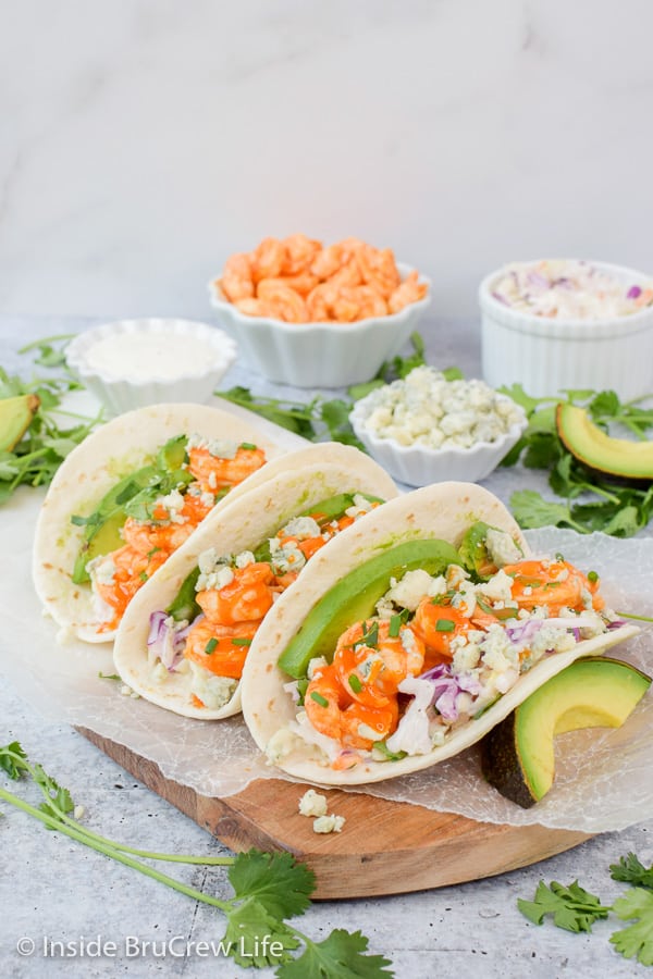 Easy Buffalo Shrimp Tacos - tortillas stuffed with toppings and buffalo shrimp can be on the table in less than 30 minutes. Try this easy recipe on busy nights! #tacos #buffaloshrimp #shrimptacos #tacotuesday