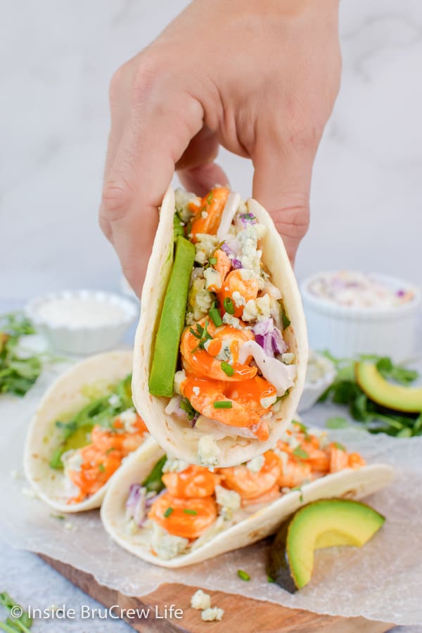 Easy Buffalo Shrimp Tacos - tortillas stuffed with toppings and buffalo shrimp will make everyone happy at the dinner table. Make this easy recipe on busy nights! #tacos #buffaloshrimp #shrimptacos #tacotuesday