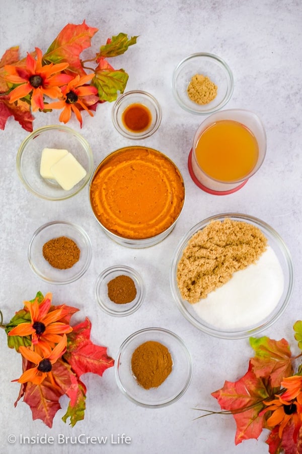 A gray board with bowls of ingredients to make homemade pumpkin butter.