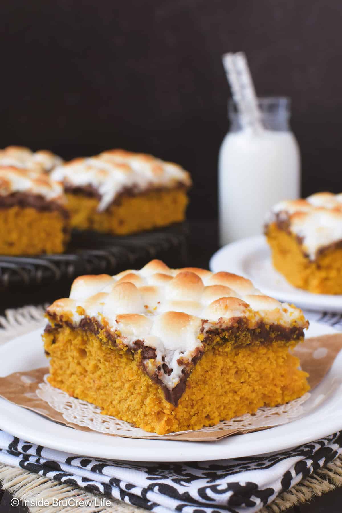 A white plate with a s'mores pumpkin bar on it.