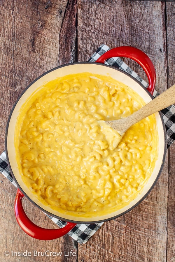 Overhead picture of a red pot filled with creamy homemade mac and cheese