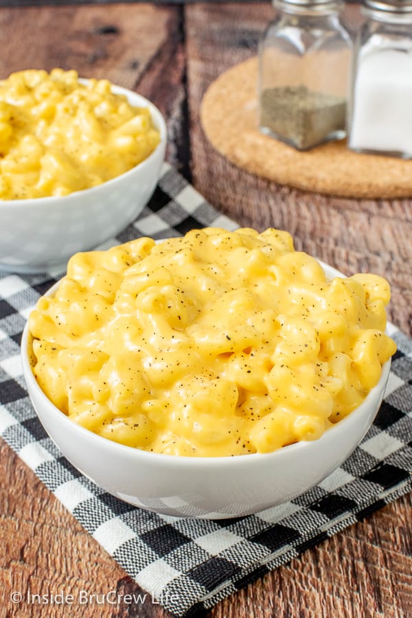 Two white bowls with a creamy mac and cheese recipe in them