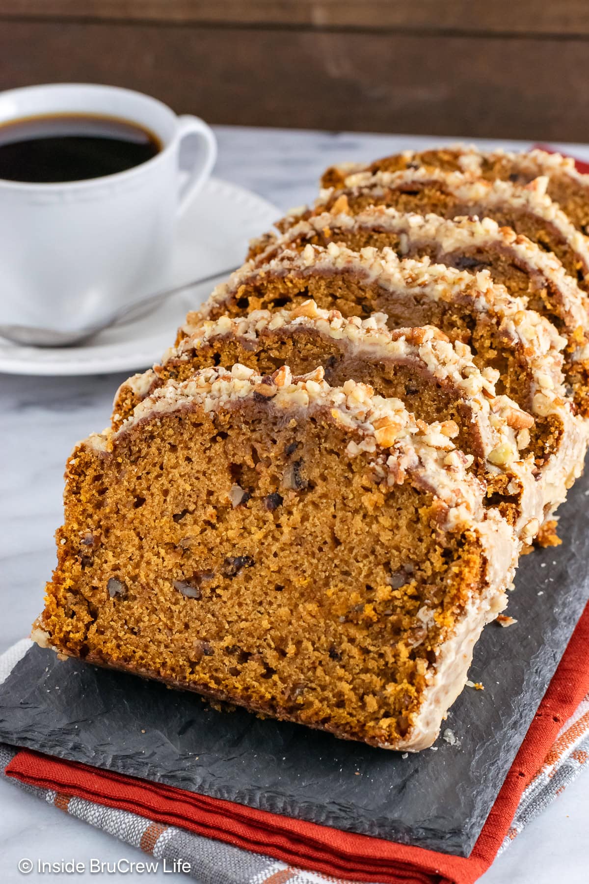 Slices of fall quick bread standing on a tray.